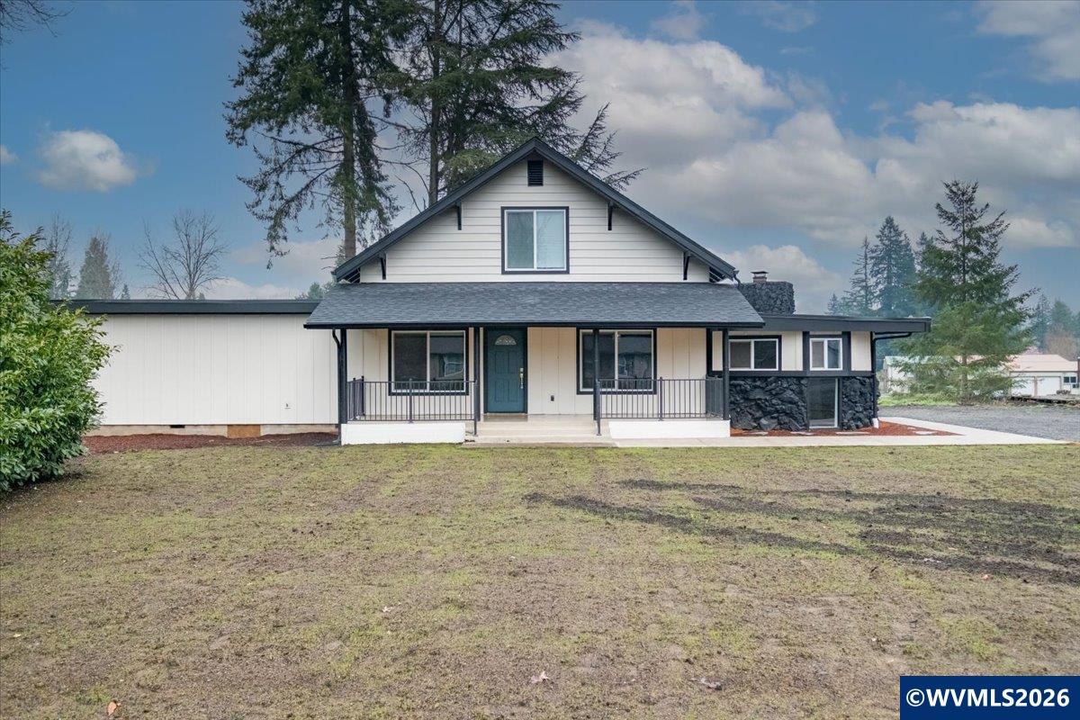 28411 Liberty Road Sweet Home, OR 97386 - Photo 4 of 50 a front view of a house with a garden and trees