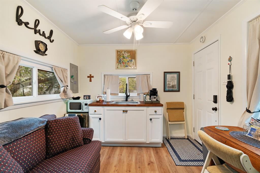 2257 Cleveland Street Paris, TX 75460 - Photo 22 of 28 a kitchen with a sink dishwasher a dining table chairs with wooden floor