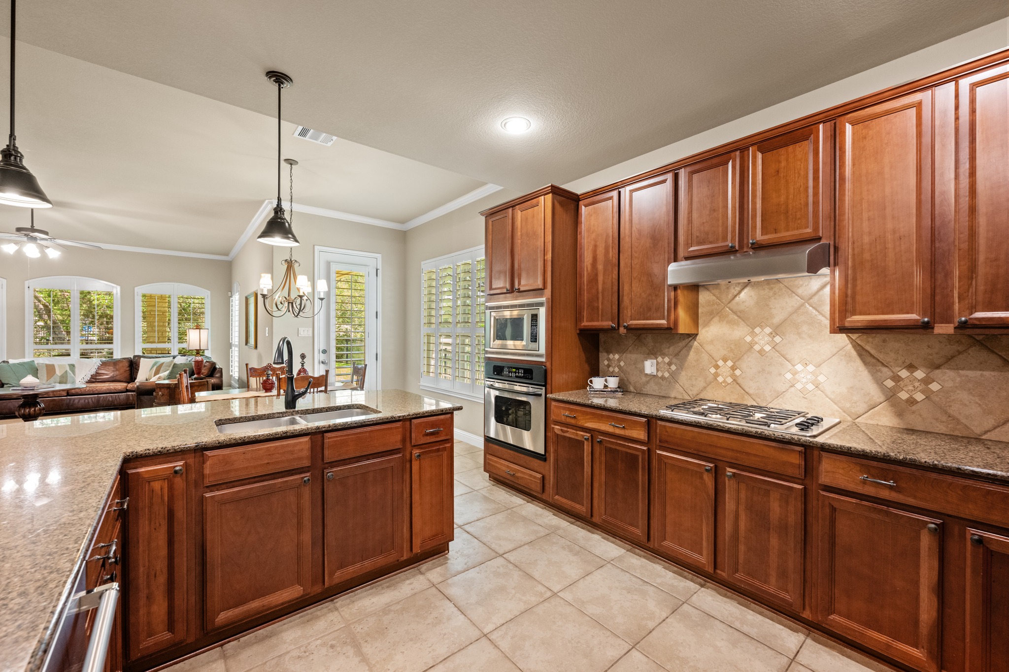 14608 Spillman Ranch Loop Austin, TX 78738 - Photo 12 of 31 a kitchen with large cabinets appliances and a large window