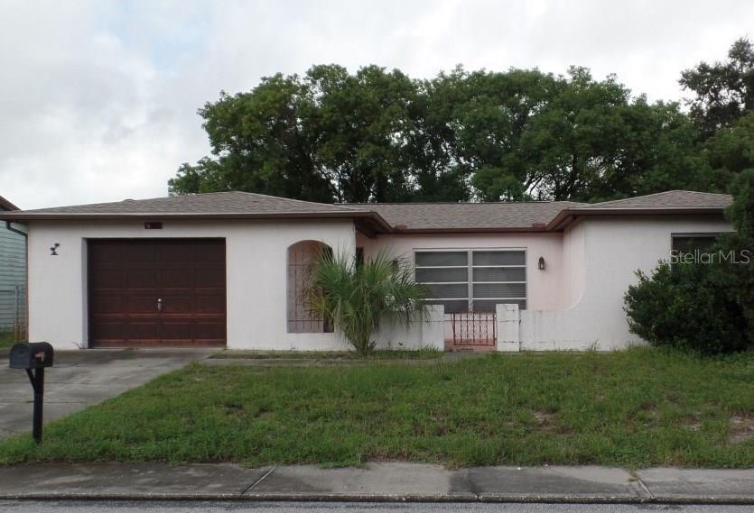 9127 Barrington Lane Port Richey, FL 34668 - Photo 1 of 1 a house view with a garden space