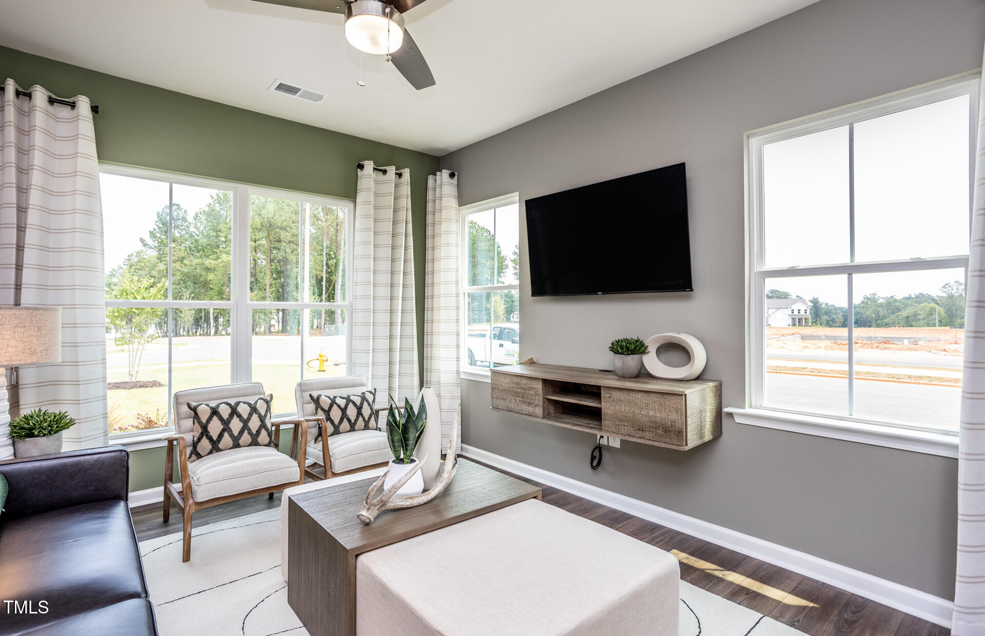 288 Fosterton Cottage Way Raleigh, NC 27603 - Photo 7 of 27 a living room with furniture a flat screen tv and a large window
