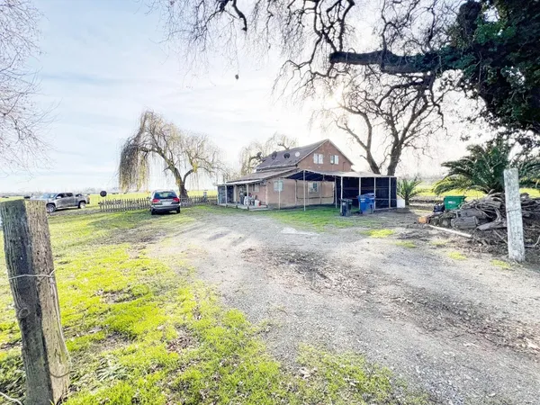 a view of a house with a yard and sitting area