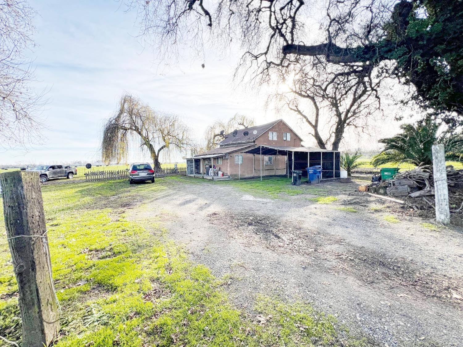 a view of a house with a yard and sitting area