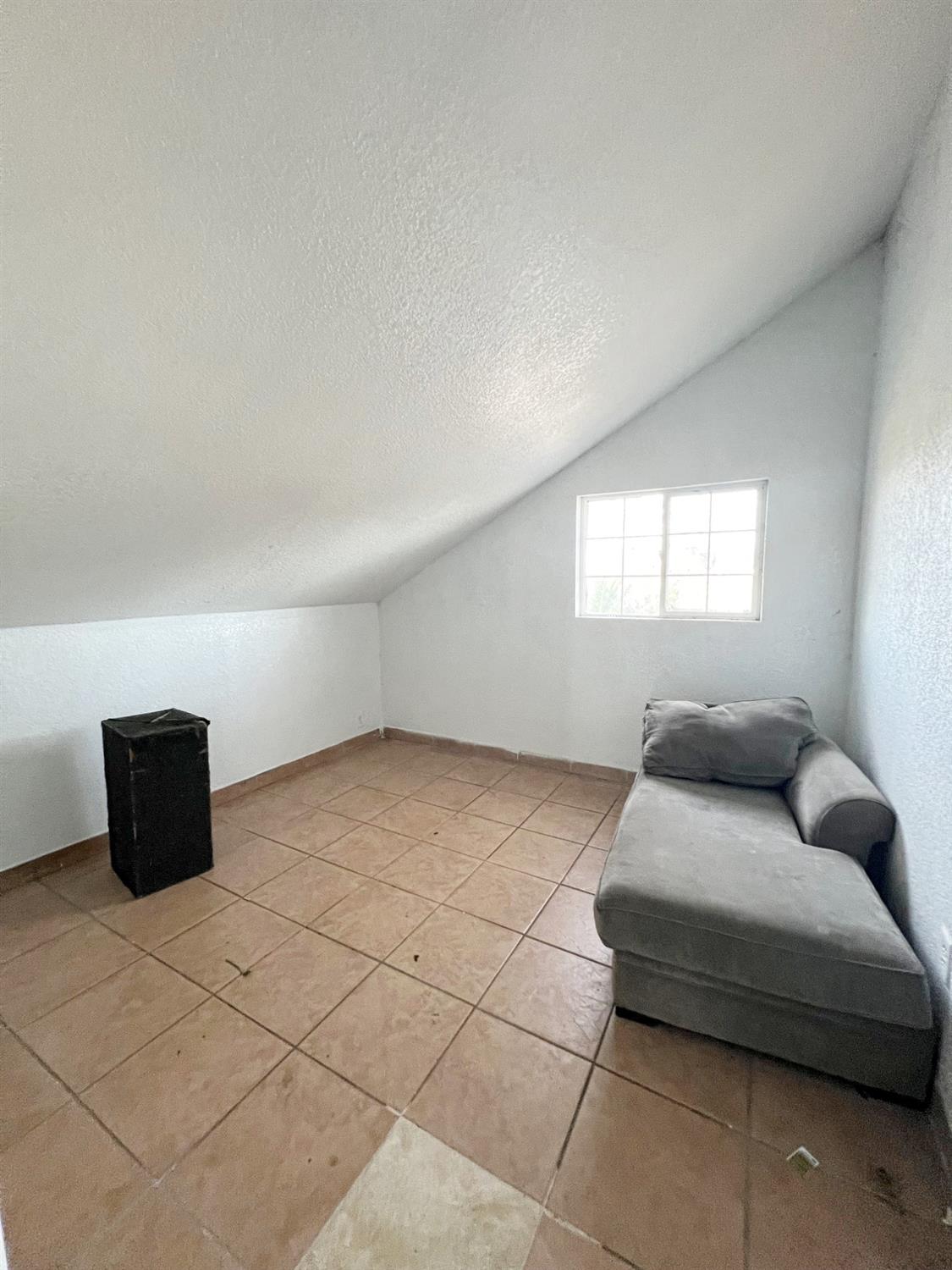 15731 Andrus Island Road Isleton, CA 95641 - Photo 11 of 40 a living room with a couch and a window