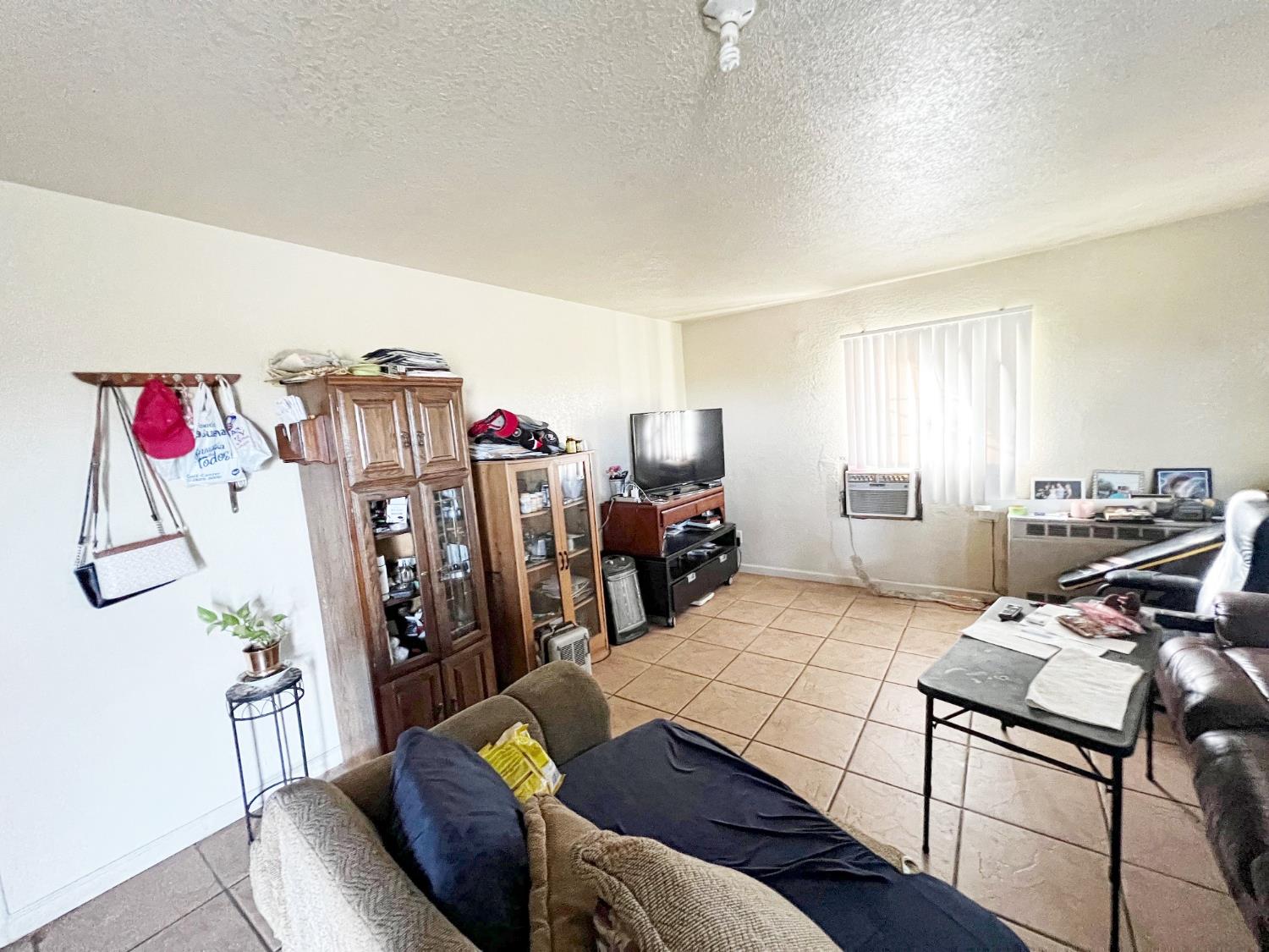 15731 Andrus Island Road Isleton, CA 95641 - Photo 19 of 40 a living room with furniture a air conditioner and a window