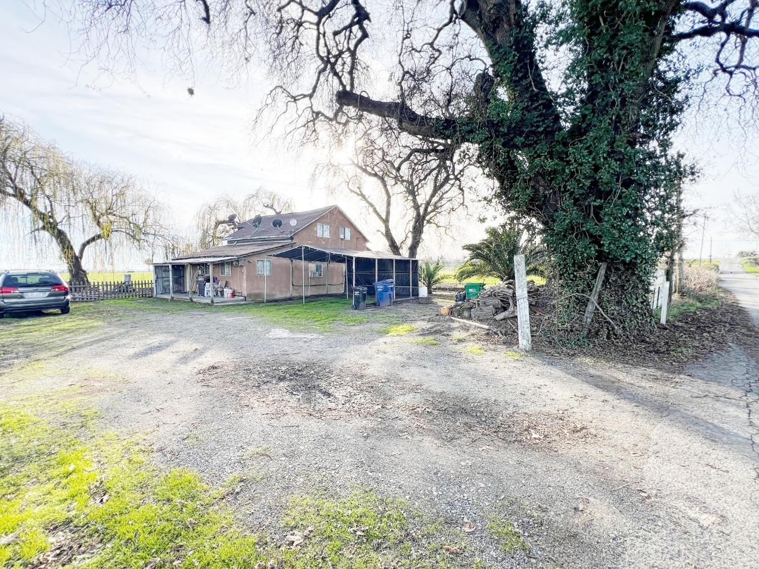 15731 Andrus Island Road Isleton, CA 95641 - Photo 2 of 40 a view of a house with a yard covered in snow