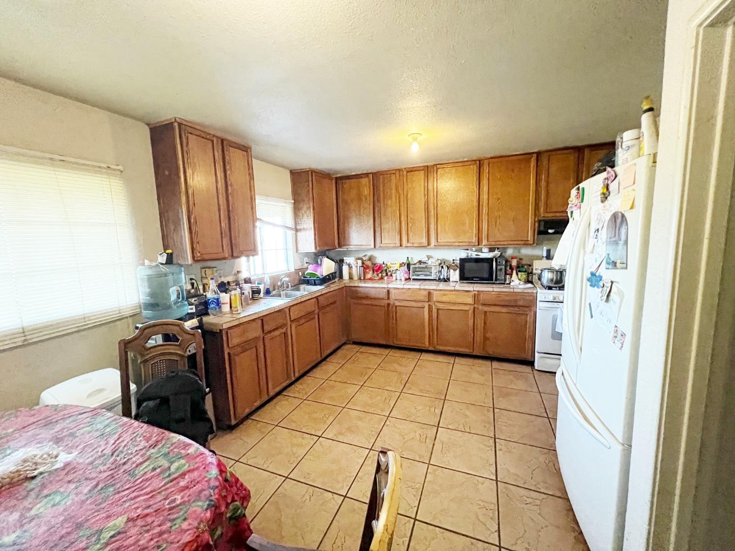 15731 Andrus Island Road Isleton, CA 95641 - Photo 22 of 40 a kitchen with a sink a window and a refrigerator