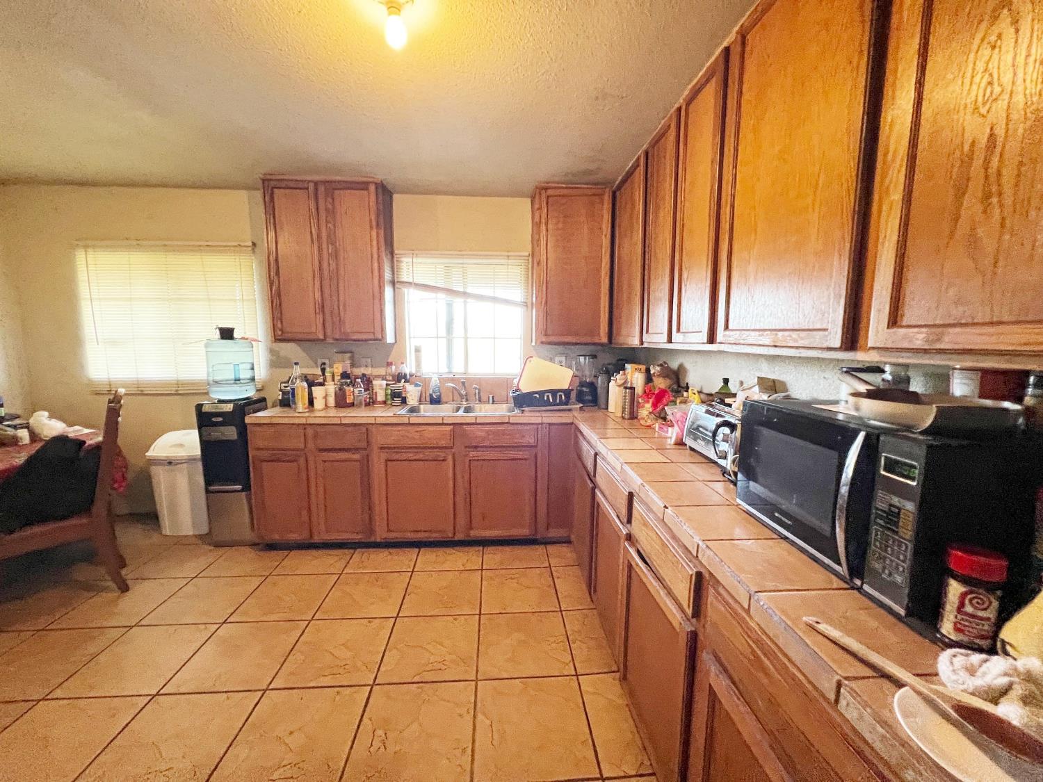 15731 Andrus Island Road Isleton, CA 95641 - Photo 23 of 40 a kitchen with a sink a stove cabinets and a dining table