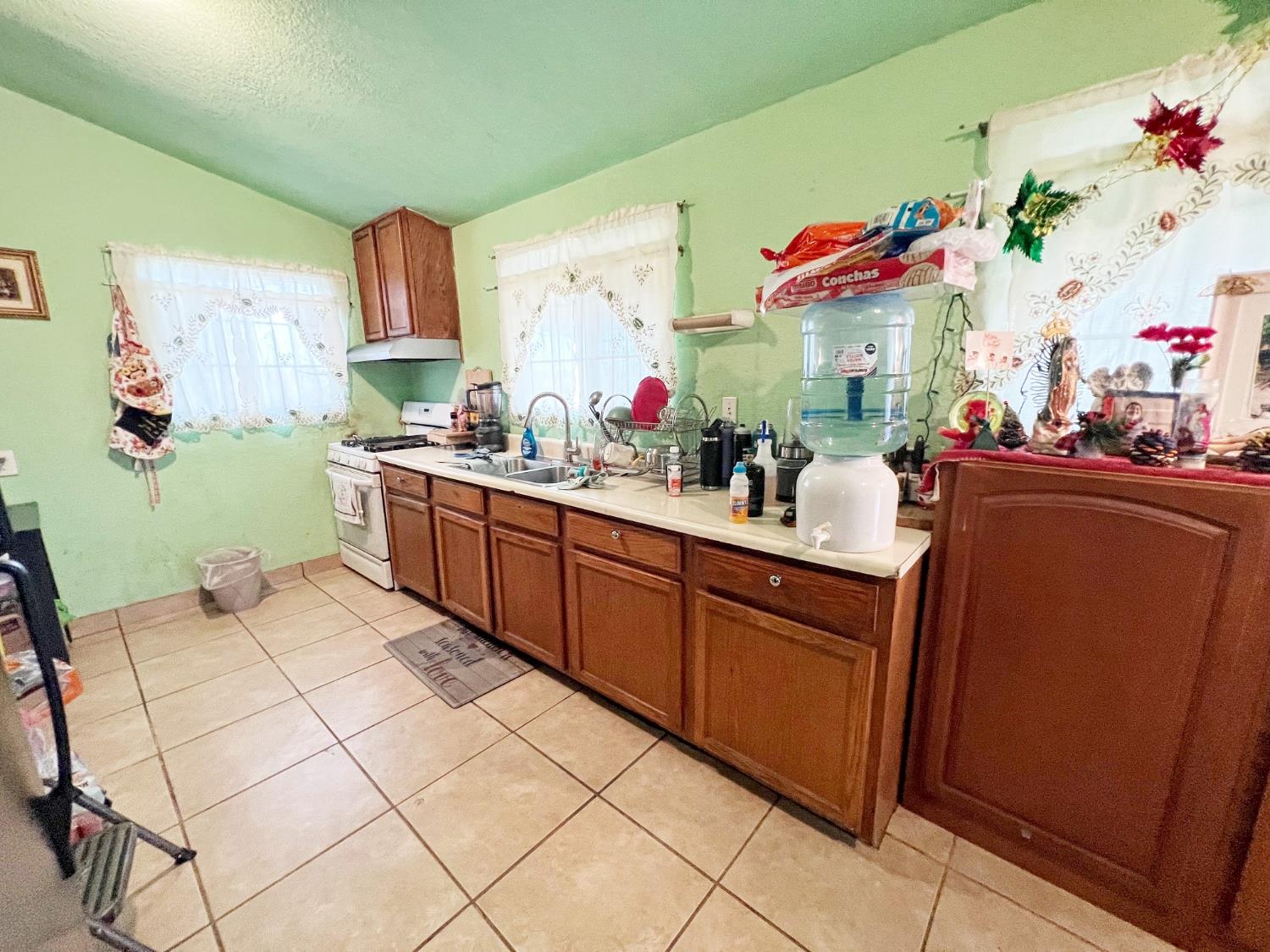 15731 Andrus Island Road Isleton, CA 95641 - Photo 6 of 40 a kitchen with sink cabinets and window