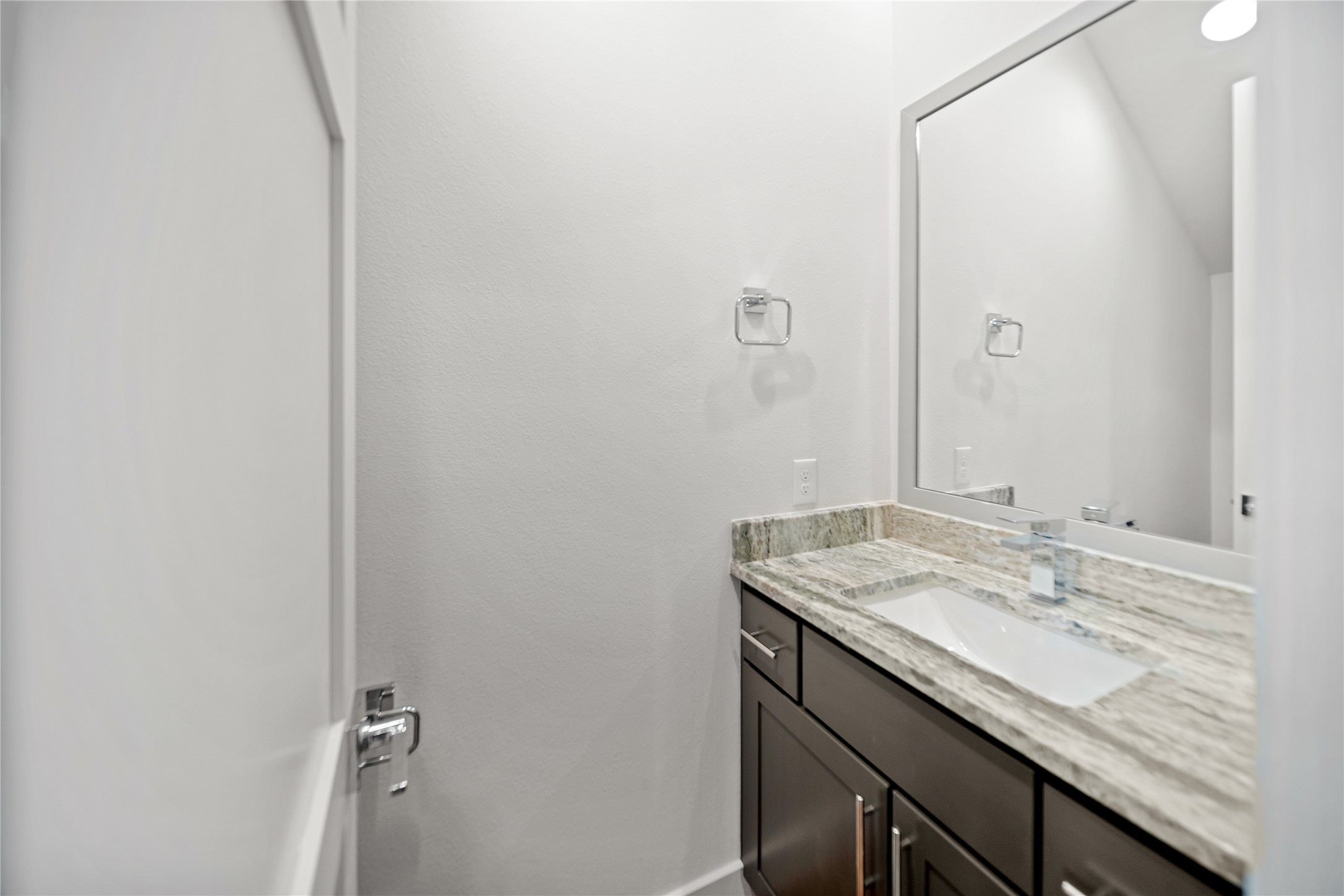 2408 Gray Street Houston, TX 77003 - Photo 18 of 23 a bathroom with a granite countertop sink and a mirror
