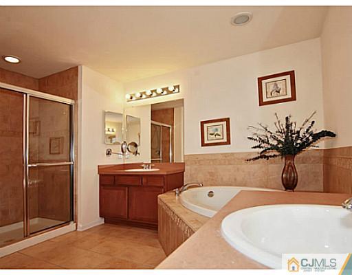 27 Raritan Reach Road South Amboy, NJ 08879 - Photo 16 of 24 a bathroom with a tub sink and mirror