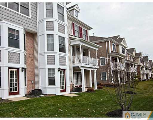 27 Raritan Reach Road South Amboy, NJ 08879 - Photo 22 of 24 front view of a brick building with a yard