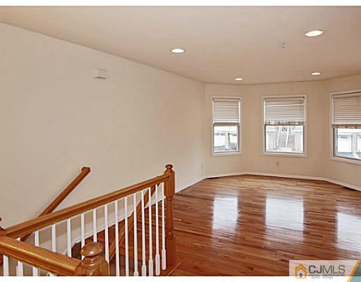 27 Raritan Reach Road South Amboy, NJ 08879 - Photo 4 of 24 a view of an empty room with wooden floor and a window