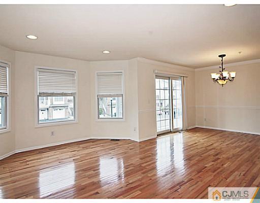 27 Raritan Reach Road South Amboy, NJ 08879 - Photo 6 of 24 an empty room with wooden floor and windows