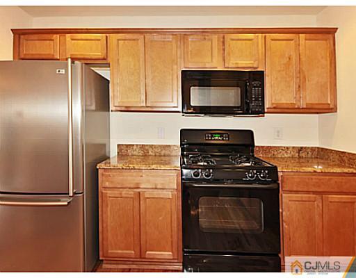 27 Raritan Reach Road South Amboy, NJ 08879 - Photo 8 of 24 a kitchen with stainless steel appliances granite countertop a refrigerator stove and microwave