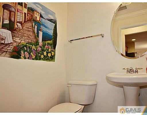 27 Raritan Reach Road South Amboy, NJ 08879 - Photo 9 of 24 a bathroom with a toilet sink and mirror
