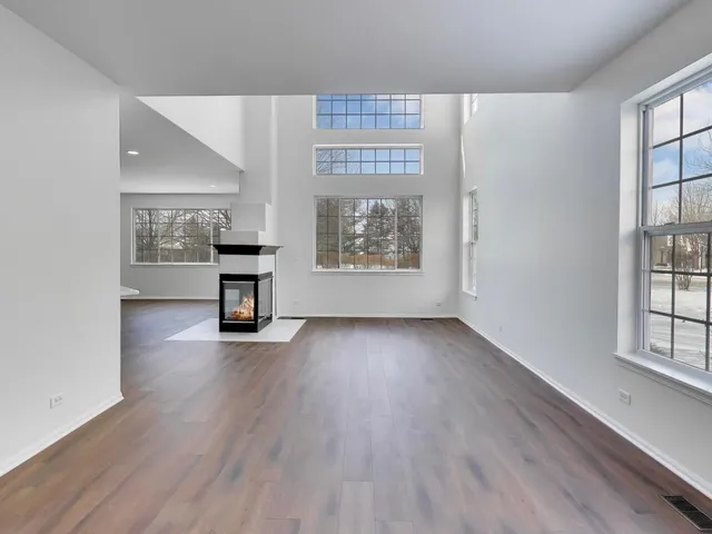 a kitchen with granite countertop white cabinets and stainless steel appliances