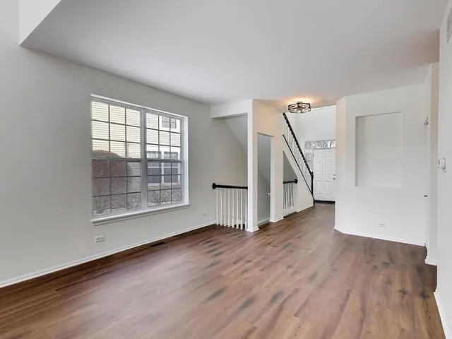 a kitchen with white cabinets and sink