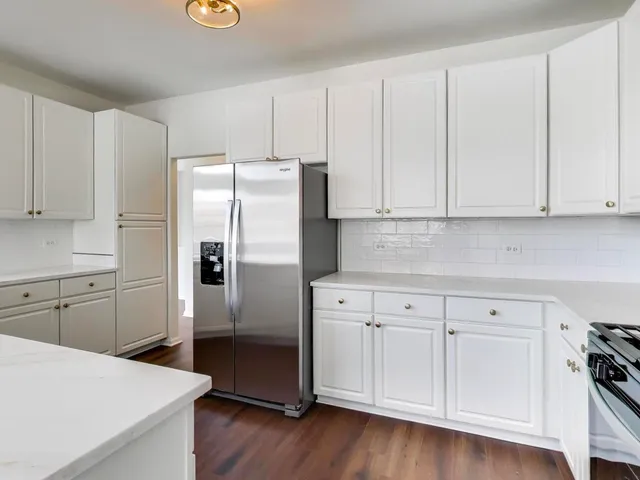 a view of a kitchen with a sink and a fireplace