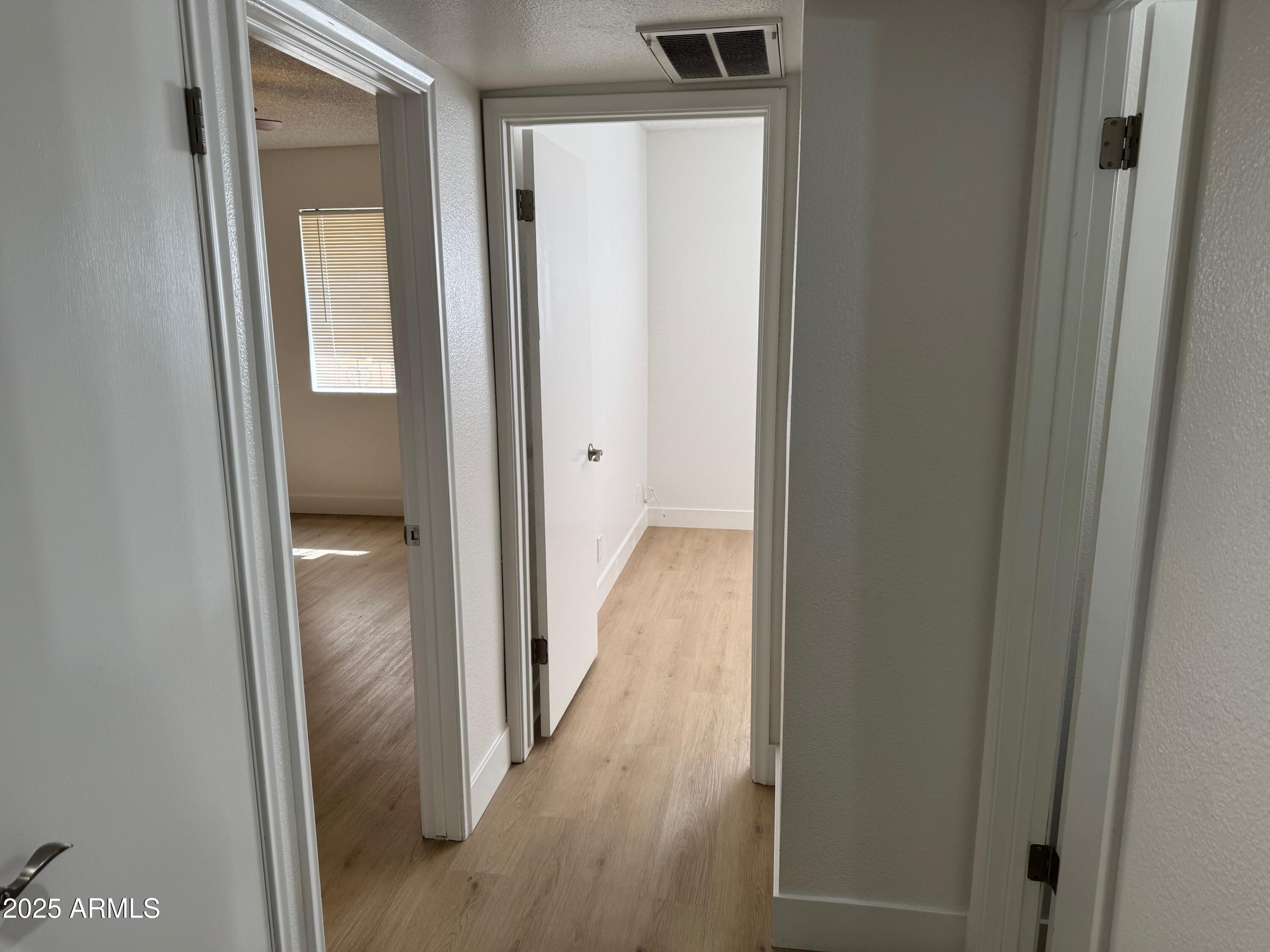8861 North 12th Place Phoenix, AZ 85020 - Photo 13 of 25 a view of a hallway with wooden floor