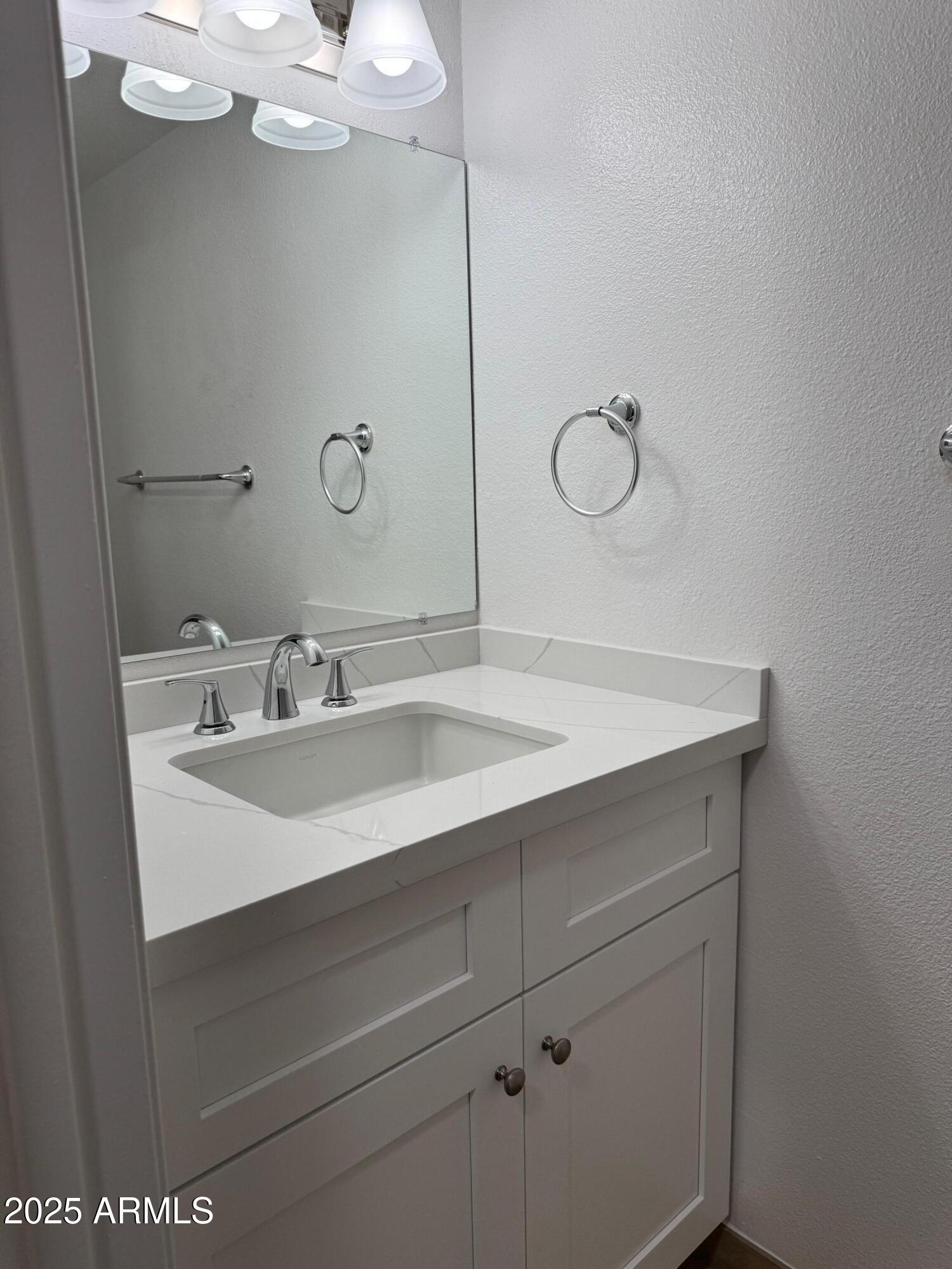 8861 North 12th Place Phoenix, AZ 85020 - Photo 15 of 25 a bathroom with a sink vanity and mirror