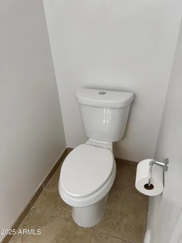 a white toilet sitting next to a white sink