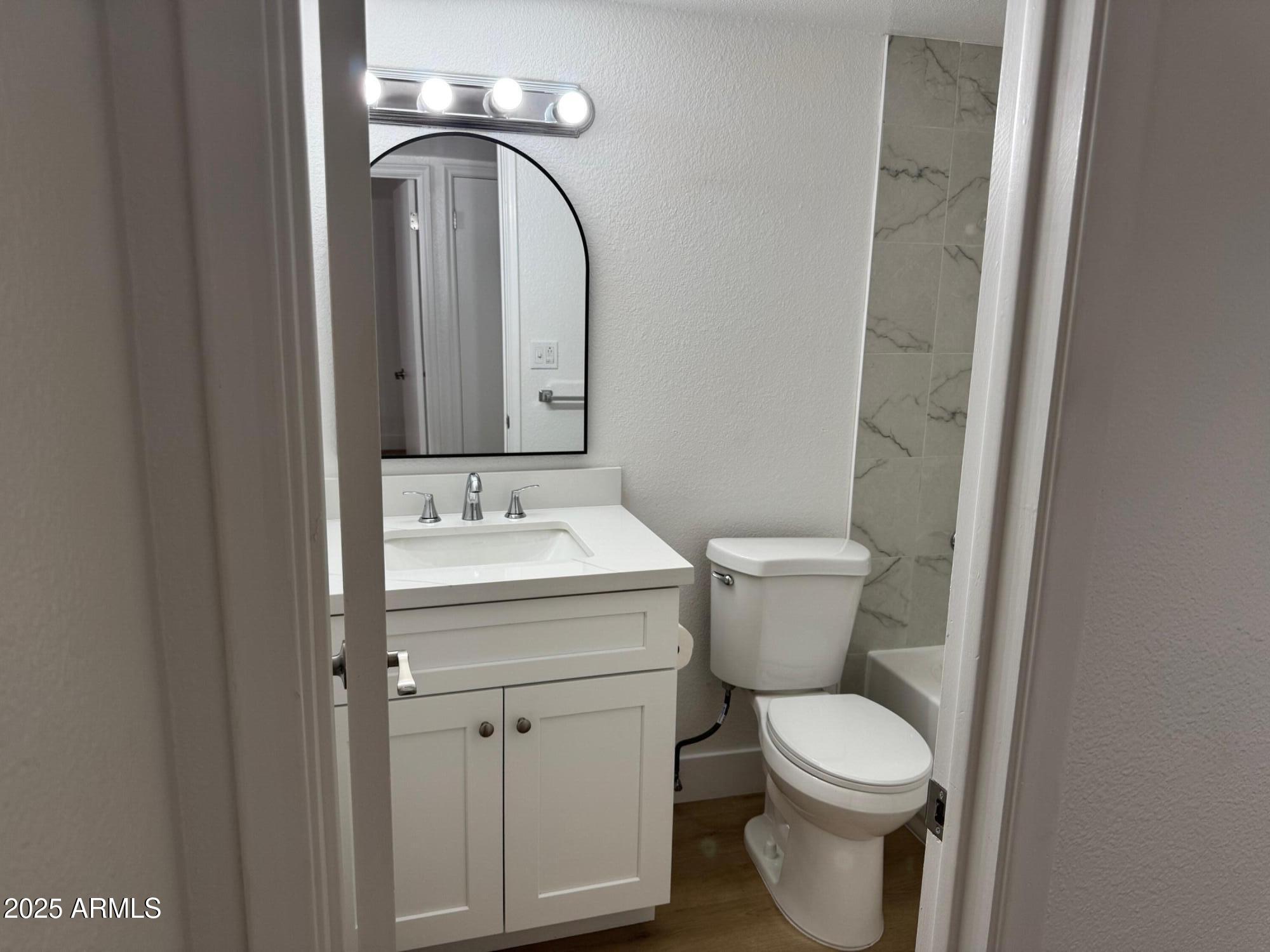 8861 North 12th Place Phoenix, AZ 85020 - Photo 20 of 25 a bathroom with a toilet sink and mirror