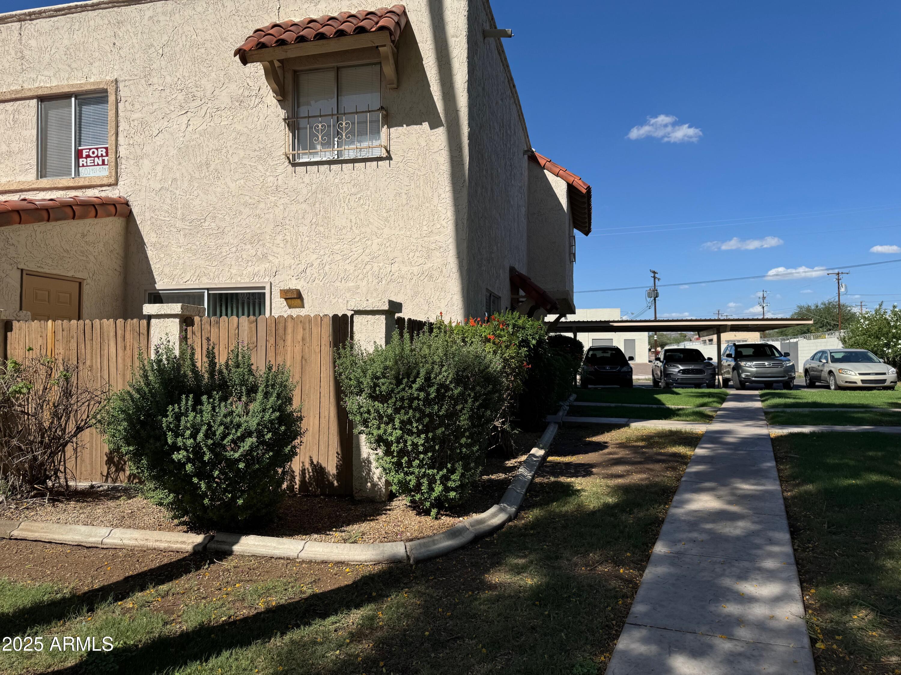 8861 North 12th Place Phoenix, AZ 85020 - Photo 2 of 25 a front view of a house with garden