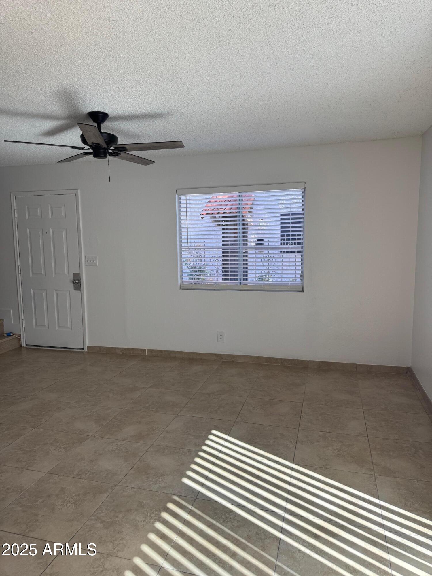 8861 North 12th Place Phoenix, AZ 85020 - Photo 5 of 25 a view of a room with a ceiling fan and window