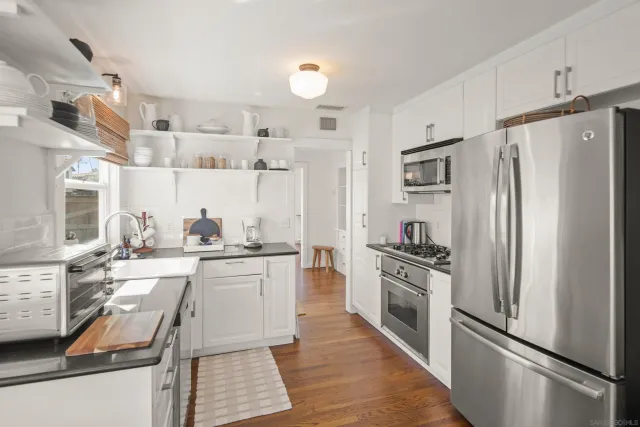 a kitchen with a sink cabinets and appliances