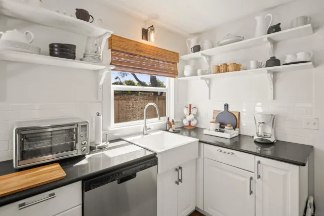 a kitchen with a sink stove and cabinets