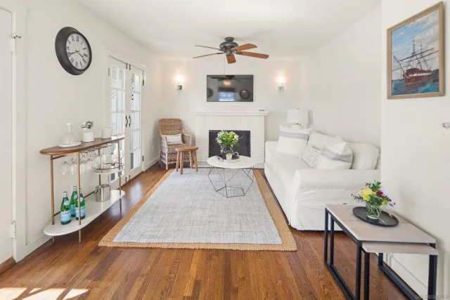 a living room with furniture a fireplace and a flat screen tv
