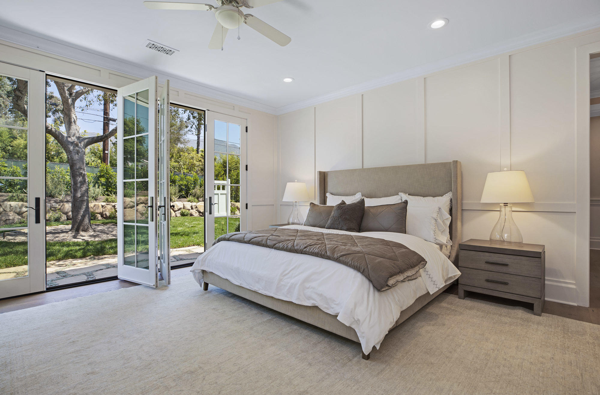 529 Santa Rosa Lane Montecito, CA 93108 - Photo 12 of 24 a spacious bedroom with a bed and a night stand