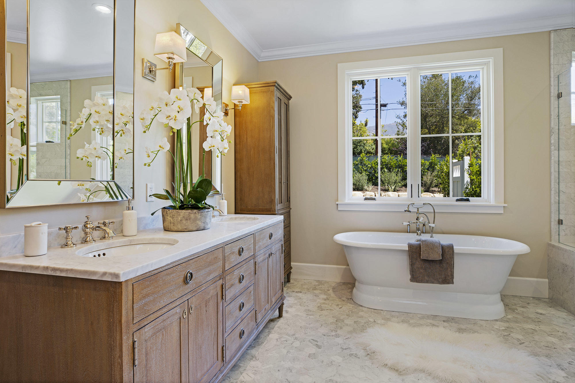 529 Santa Rosa Lane Montecito, CA 93108 - Photo 13 of 24 a bathroom with a double vanity sink bathtub and window