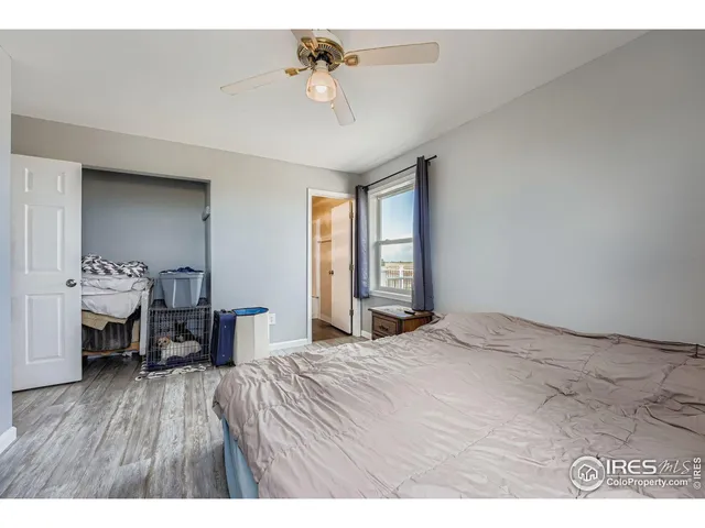 a spacious bedroom with a bed and a window