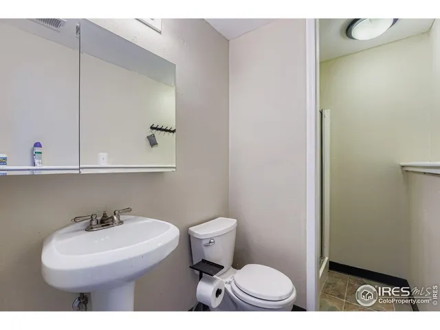 a bathroom with a sink a toilet and mirror