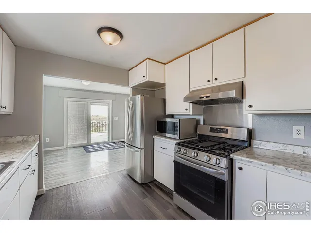 a kitchen with stainless steel appliances a stove a sink and a refrigerator