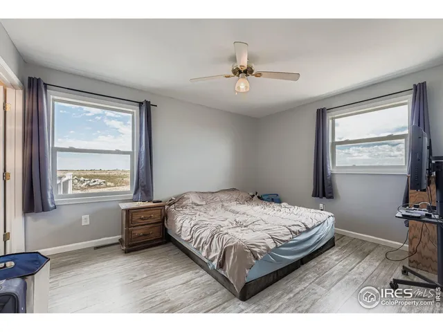 a bedroom with a bed window and a table