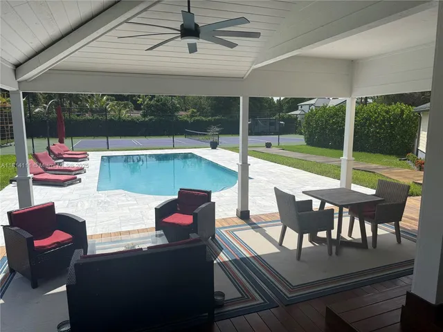 a outdoor space with patio the couches and pool table with chairs