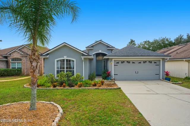 a front view of house with yard and green space