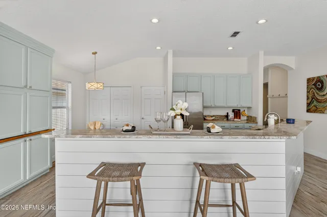 a kitchen with stainless steel appliances kitchen island granite countertop a sink and cabinets