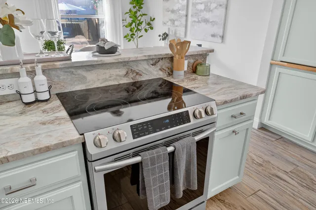 a stove top oven sitting inside of a kitchen