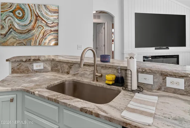 a kitchen with a sink and a stove top oven