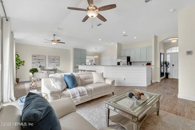 a living room with furniture and kitchen view