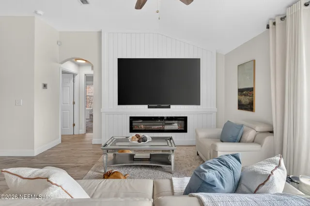 a living room with furniture and a flat screen tv