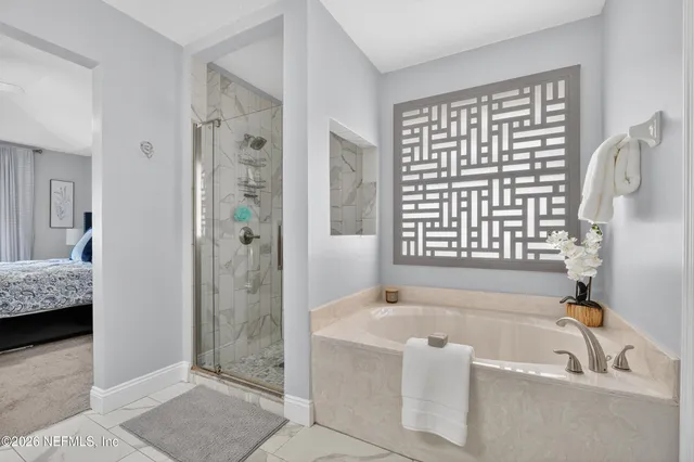 a bathroom with a bathtub and a shower