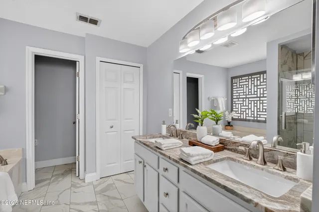 a bathroom with a sink double vanity and a mirror