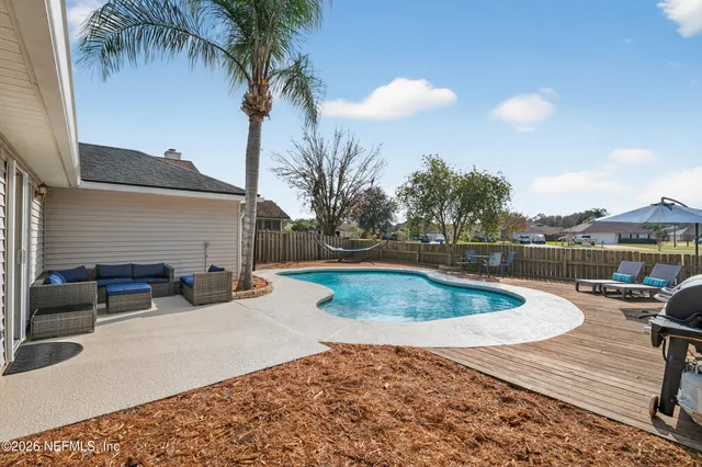 a view of a swimming pool with a patio