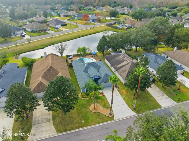 an aerial view of residential houses with outdoor space and swimming pool