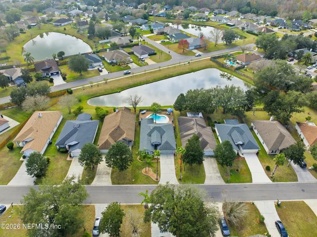 an aerial view of residential houses with outdoor space